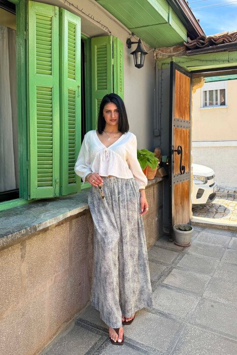 PANTALONA TE GJERA ME DIZENJO TE NDRYSHME PER FEMRA NE NGJYRE TE BARDHE - KLAUDIO FASHION